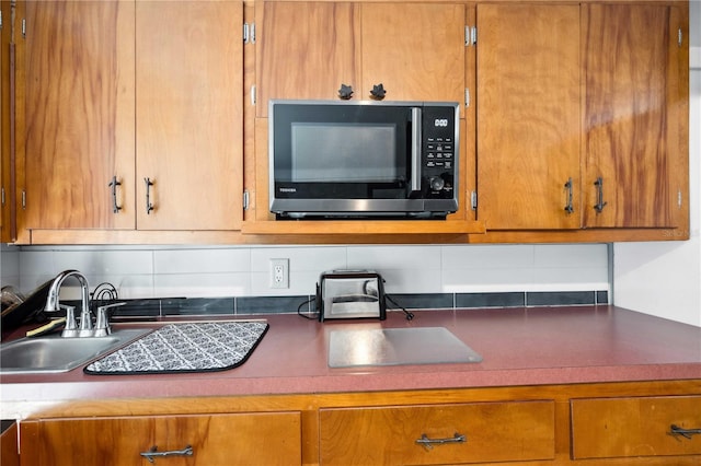 36601 Roberts Rd, Dade City, FL 33525 - kitchen with a sink, backsplash, and brown cabinets