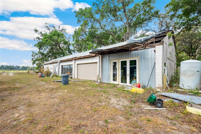 36601 Roberts Rd, Dade City, FL 33525 - view of property exterior with an attached garage, french doors, and concrete block siding