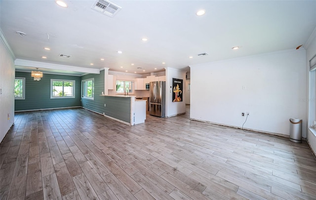 unfurnished living room featuring recessed lighting, visible vents, and ornamental molding