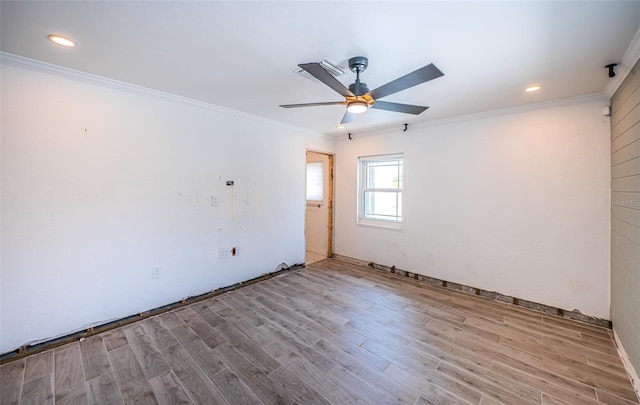 spare room with ornamental molding, a ceiling fan, and wood finished floors