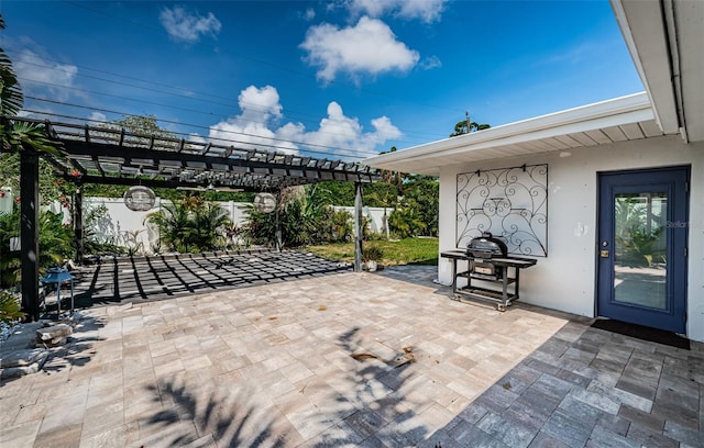 view of patio with fence, a pergola, and area for grilling