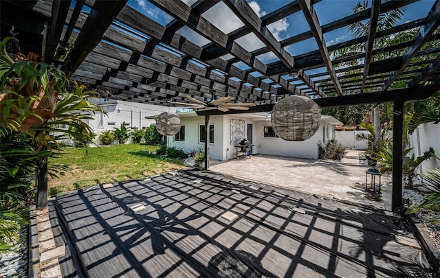 view of patio with a ceiling fan, fence, and a pergola