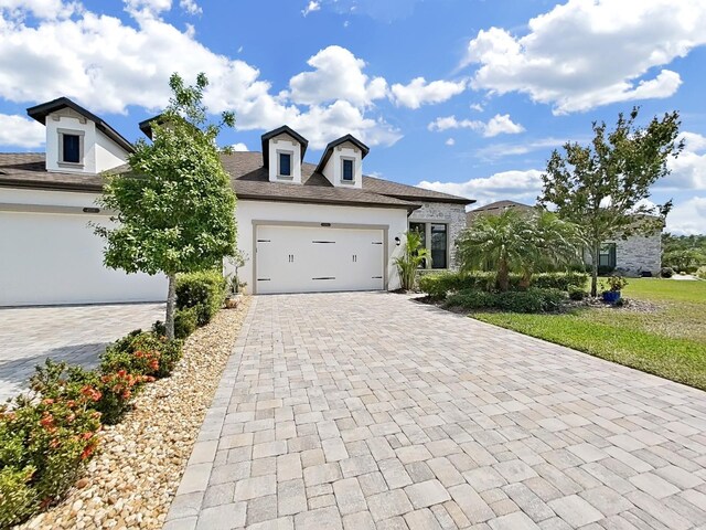 4300 Barletta Ct, Wesley Chapel, FL 33543 - view of front facade with stucco siding, decorative driveway, and an attached garage