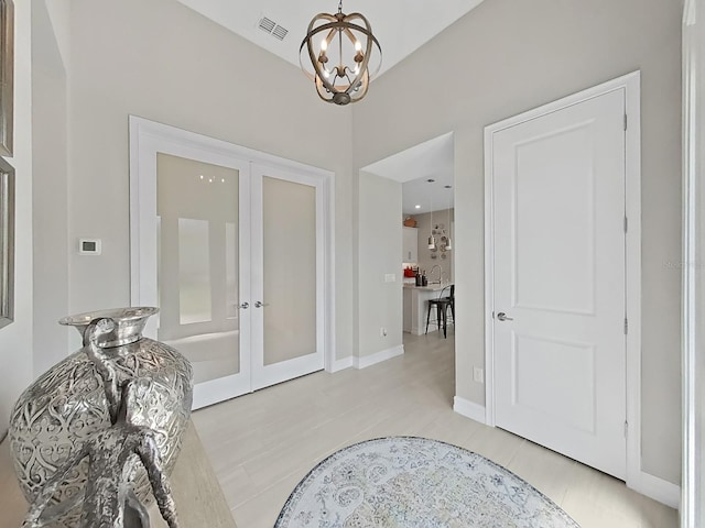 4300 Barletta Ct, Wesley Chapel, FL 33543 - foyer featuring french doors, a chandelier, and baseboards