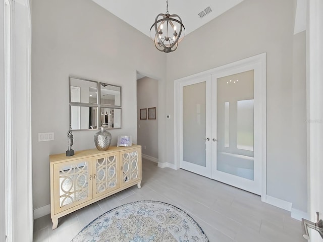 4300 Barletta Ct, Wesley Chapel, FL 33543 - doorway with a chandelier, french doors, baseboards, and tile patterned floors