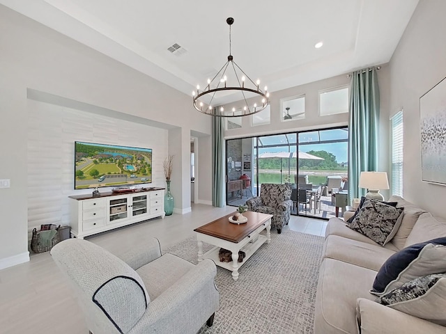 4300 Barletta Ct, Wesley Chapel, FL 33543 - living room featuring a chandelier, baseboards, recessed lighting, and a towering ceiling