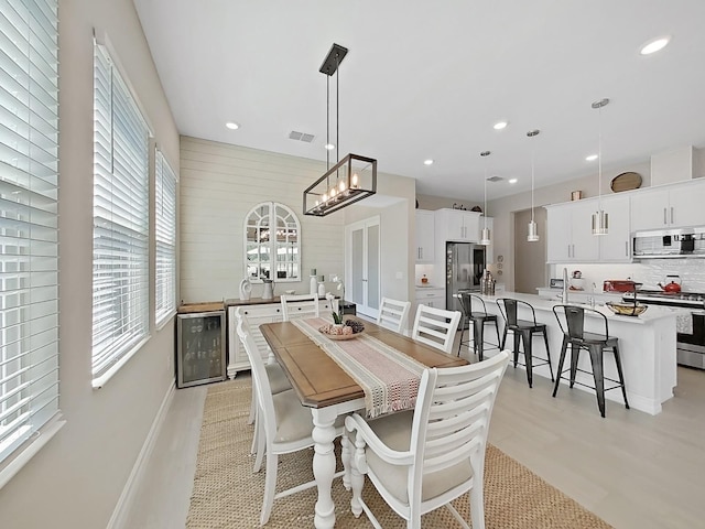 4300 Barletta Ct, Wesley Chapel, FL 33543 - dining area featuring beverage cooler, recessed lighting, a chandelier, and baseboards