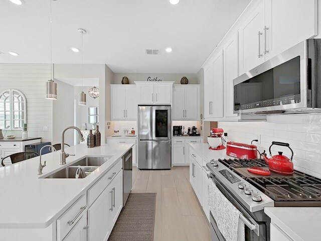 4300 Barletta Ct, Wesley Chapel, FL 33543 - kitchen with stainless steel appliances, a sink, tasteful backsplash, recessed lighting, and light countertops