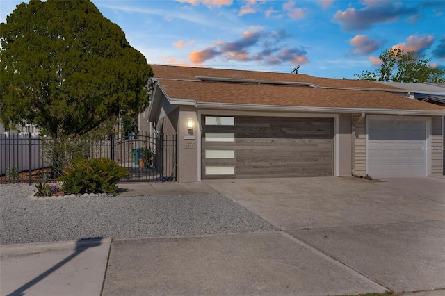 105 E Davis Blvd Unit A, Tampa, FL 33606 - view of front of home featuring concrete driveway, a garage, fence, and stucco siding