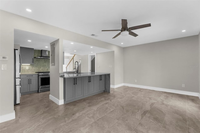 105 E Davis Blvd Unit A, Tampa, FL 33606 - kitchen with ceiling fan, wall chimney exhaust hood, gray cabinets, tasteful backsplash, and appliances with stainless steel finishes