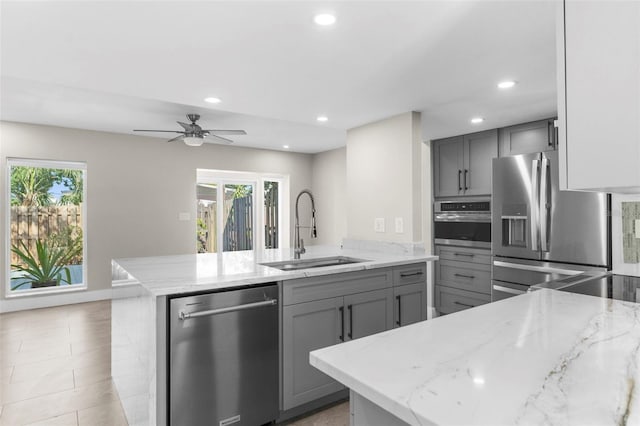 105 E Davis Blvd Unit A, Tampa, FL 33606 - kitchen featuring a peninsula, recessed lighting, a sink, appliances with stainless steel finishes, and gray cabinetry