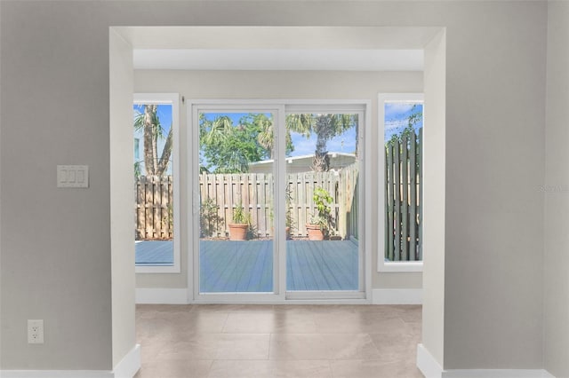 105 E Davis Blvd Unit A, Tampa, FL 33606 - doorway with baseboards, plenty of natural light, and tile patterned flooring
