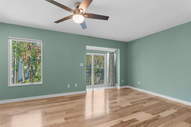 105 E Davis Blvd Unit A, Tampa, FL 33606 - unfurnished room featuring a ceiling fan, baseboards, a healthy amount of sunlight, and wood finished floors