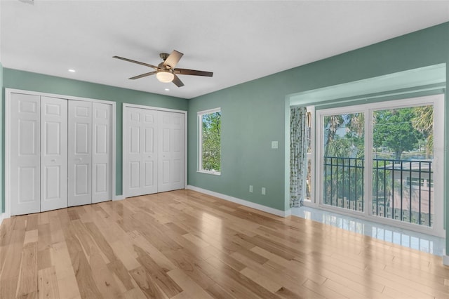 105 E Davis Blvd Unit A, Tampa, FL 33606 - unfurnished bedroom with multiple closets, wood finished floors, baseboards, recessed lighting, and access to outside