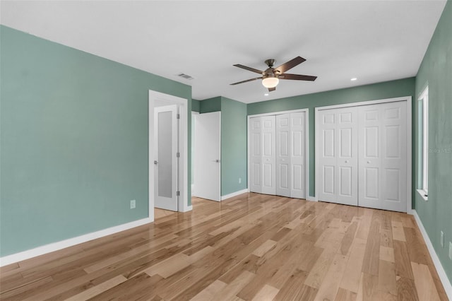 105 E Davis Blvd Unit A, Tampa, FL 33606 - unfurnished bedroom with two closets, baseboards, visible vents, and light wood-style flooring