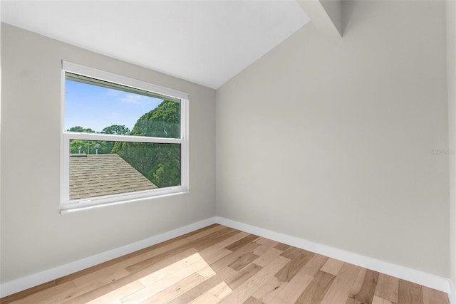 105 E Davis Blvd Unit A, Tampa, FL 33606 - empty room with light wood-type flooring, baseboards, and lofted ceiling