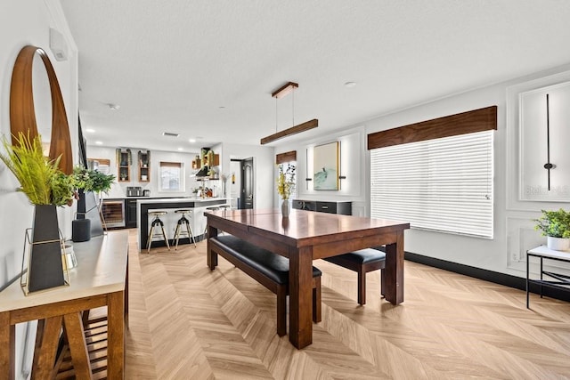 dining room with wine cooler, plenty of natural light, and recessed lighting