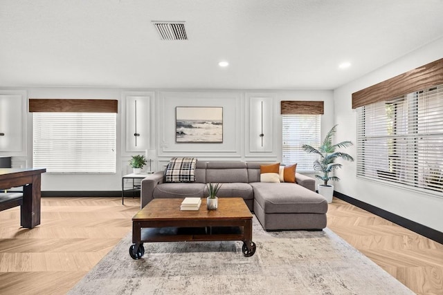 living room with baseboards, recessed lighting, and visible vents