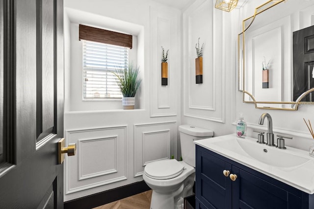 bathroom featuring vanity and toilet