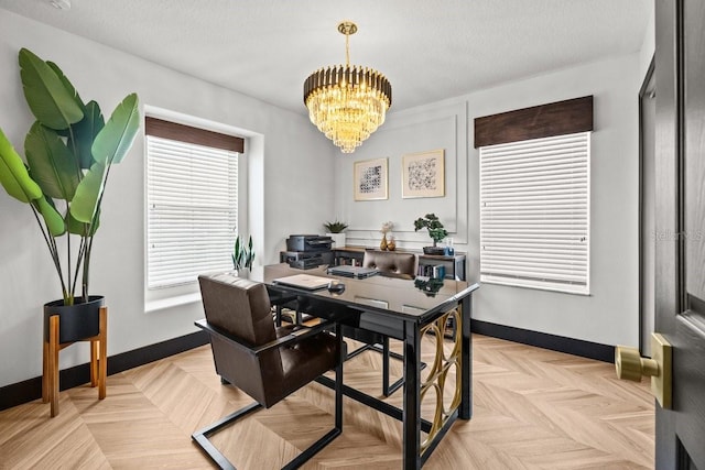office area with baseboards and a notable chandelier