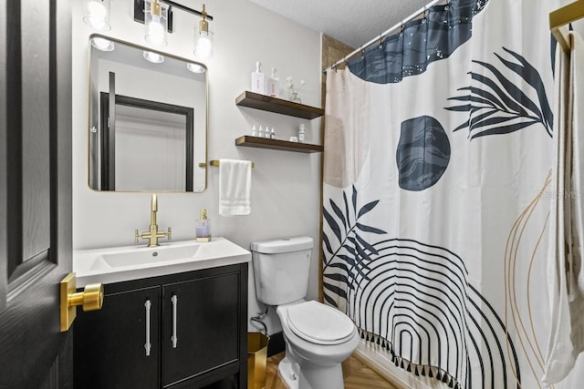 full bathroom with vanity, a textured ceiling, a shower with shower curtain, and toilet