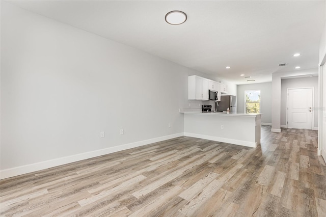 unfurnished living room featuring recessed lighting, baseboards, visible vents, and light wood-style flooring