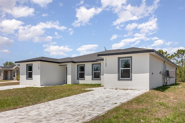 prairie-style home with stucco siding and a front yard