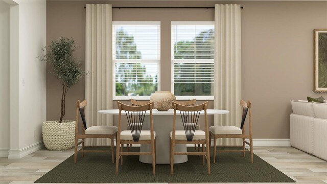 11554 71st Ave E, Palmetto, FL 34221 - dining space with baseboards and light wood-type flooring