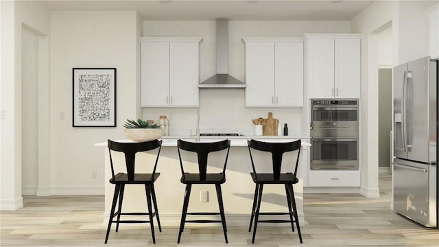 11554 71st Ave E, Palmetto, FL 34221 - kitchen with white cabinetry, light wood-style flooring, wall chimney range hood, and stainless steel appliances