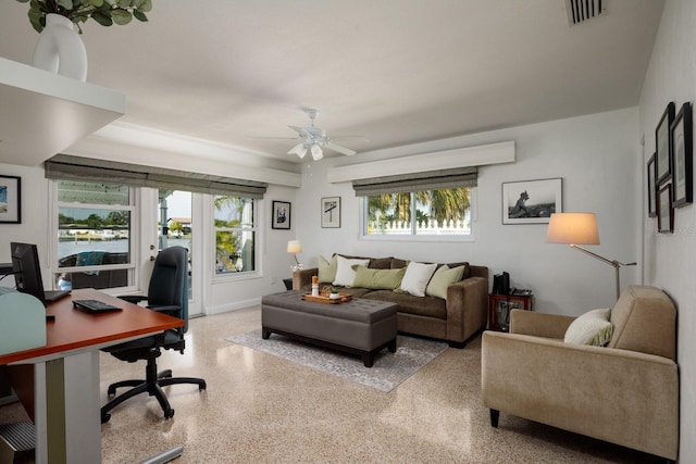 2487 W Bay Isle Dr SE, Saint Petersburg, FL 33705 - living area featuring light speckled floor, visible vents, ceiling fan, and a healthy amount of sunlight