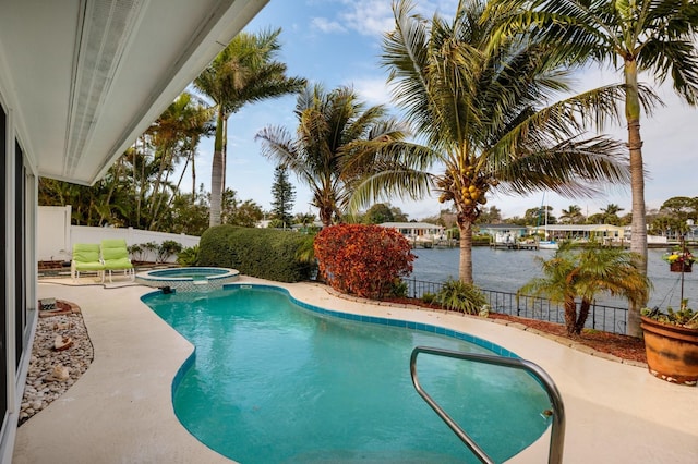 2487 W Bay Isle Dr SE, Saint Petersburg, FL 33705 - view of pool with a patio, a fenced backyard, a pool with connected hot tub, and a water view