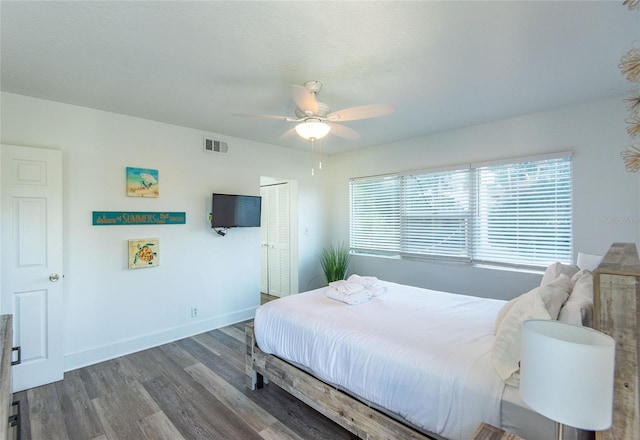 bedroom with visible vents, baseboards, ceiling fan, and wood finished floors