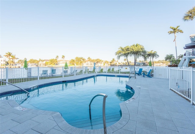 community pool featuring fence and a patio