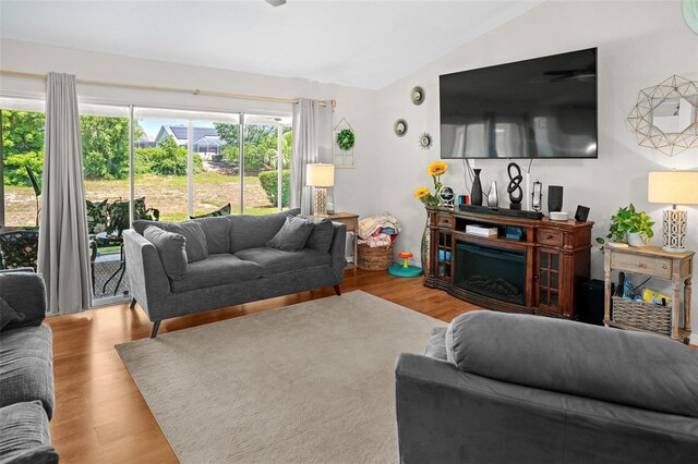 8712 Ashbury Dr, Hudson, FL 34667 - living area featuring wood finished floors and lofted ceiling