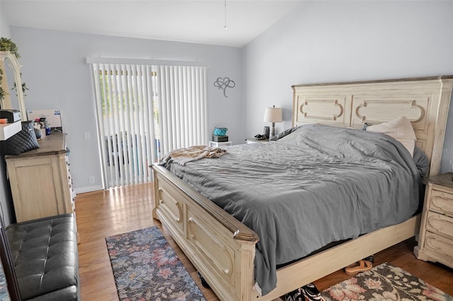 8712 Ashbury Dr, Hudson, FL 34667 - bedroom with access to exterior, wood finished floors, and lofted ceiling