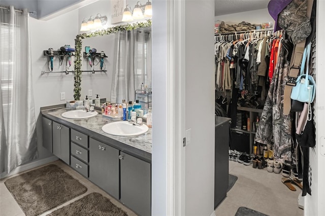 8712 Ashbury Dr, Hudson, FL 34667 - full bathroom with a sink, tile patterned flooring, double vanity, and a spacious closet
