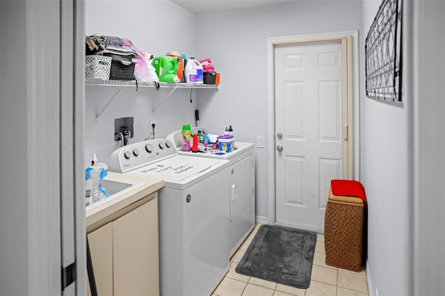 8712 Ashbury Dr, Hudson, FL 34667 - washroom featuring independent washer and dryer, laundry area, and light tile patterned floors