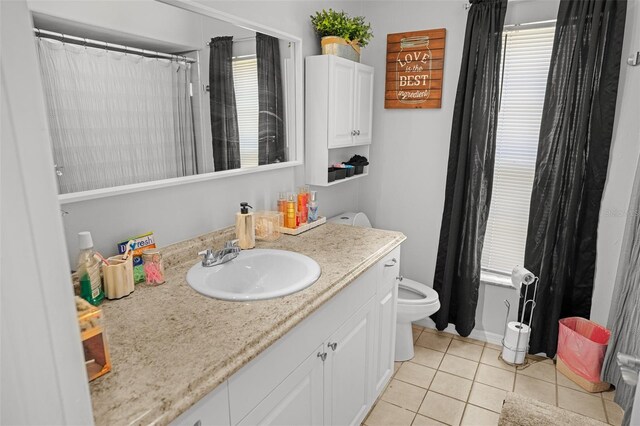 8712 Ashbury Dr, Hudson, FL 34667 - full bathroom with tile patterned floors, vanity, toilet, and a wealth of natural light