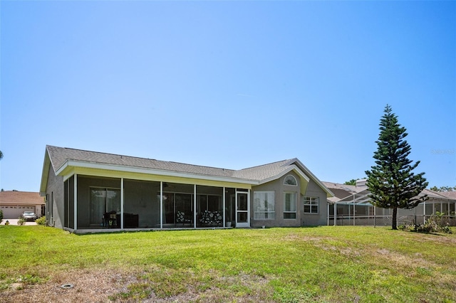 8712 Ashbury Dr, Hudson, FL 34667 - back of house with a yard, stucco siding, and a sunroom