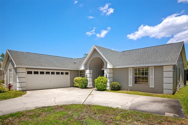 8712 Ashbury Dr, Hudson, FL 34667 - ranch-style house with roof with shingles, stucco siding, and driveway