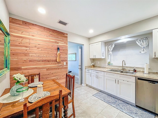149 Sky Loch Dr E, Dunedin, FL 34698 - kitchen with visible vents, stainless steel dishwasher, white cabinetry, a sink, and light tile patterned flooring