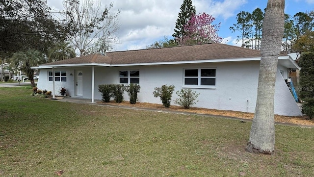 3188 Lake Saxon Dr, Land O Lakes, FL 34639 - view of front of property with a shingled roof, stucco siding, and a front lawn