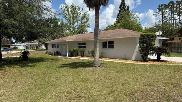 3188 Lake Saxon Dr, Land O Lakes, FL 34639 - back of property with stucco siding and a yard