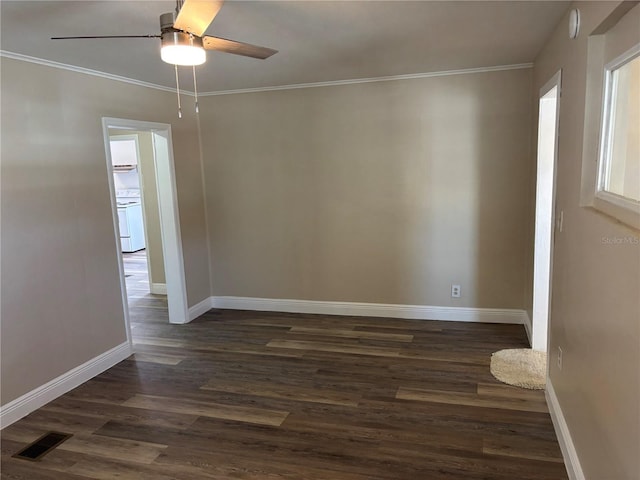 empty room featuring a ceiling fan, visible vents, crown molding, baseboards, and dark wood-style floors