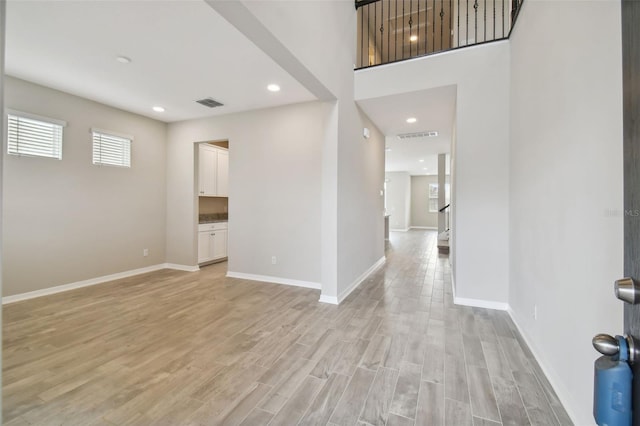 foyer entrance with recessed lighting, baseboards, visible vents, and light wood finished floors