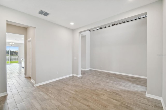 spare room with visible vents, recessed lighting, baseboards, and light wood-type flooring