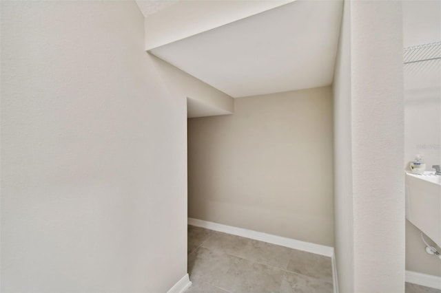 interior space with baseboards and tile patterned flooring