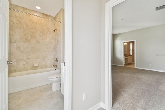 bathroom featuring toilet, tile patterned floors, baseboards, shower / bathing tub combination, and visible vents