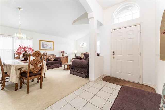 29542 Forest Glen Dr, Wesley Chapel, FL 33543 - foyer entrance with an inviting chandelier, light carpet, arched walkways, high vaulted ceiling, and light tile patterned floors