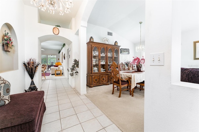 29542 Forest Glen Dr, Wesley Chapel, FL 33543 - hall featuring light colored carpet, a notable chandelier, light tile patterned floors, and lofted ceiling